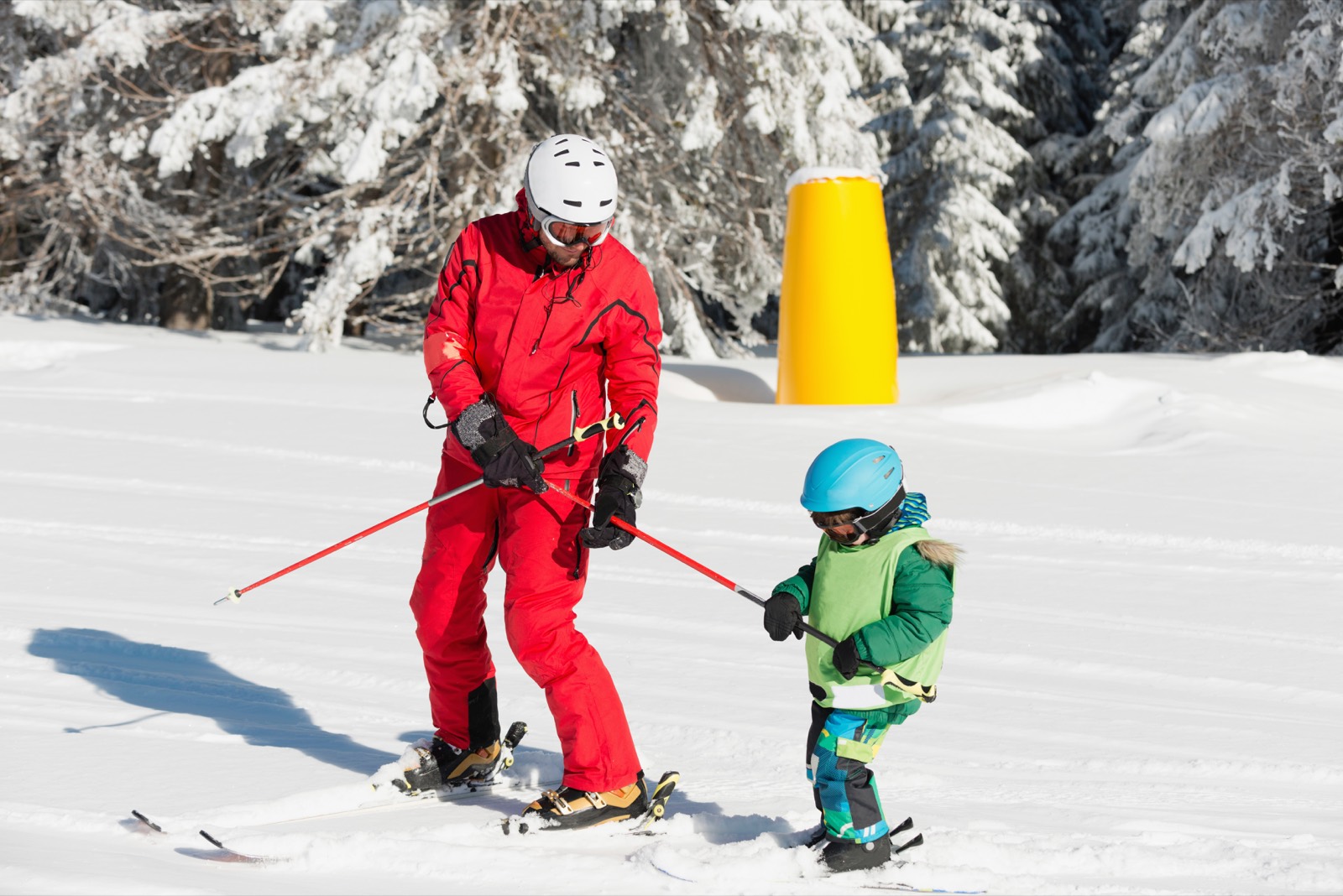 Instructor teaching a child to ski at Sugar Bowl